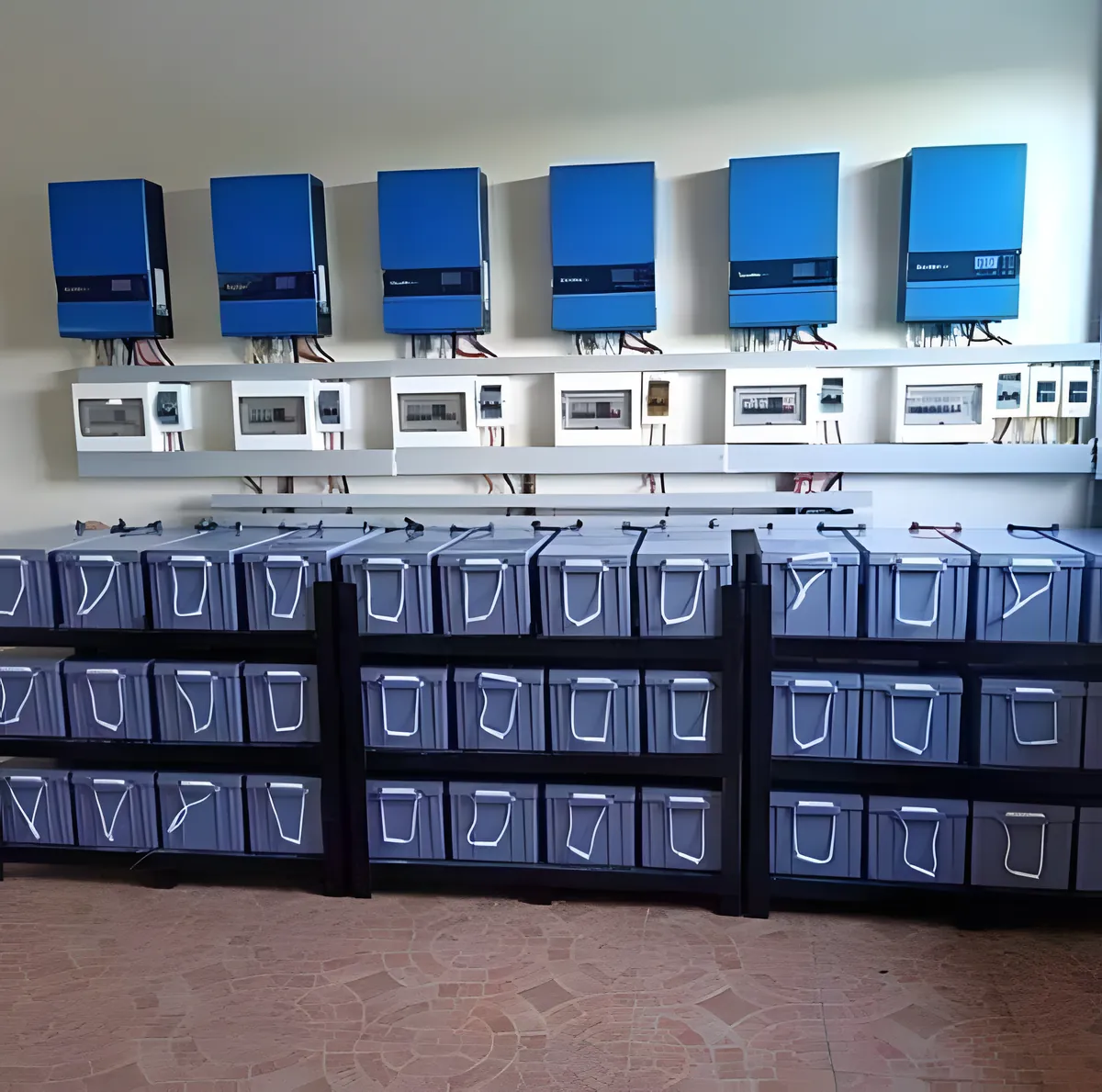 Six inverters above a large bank of batteries