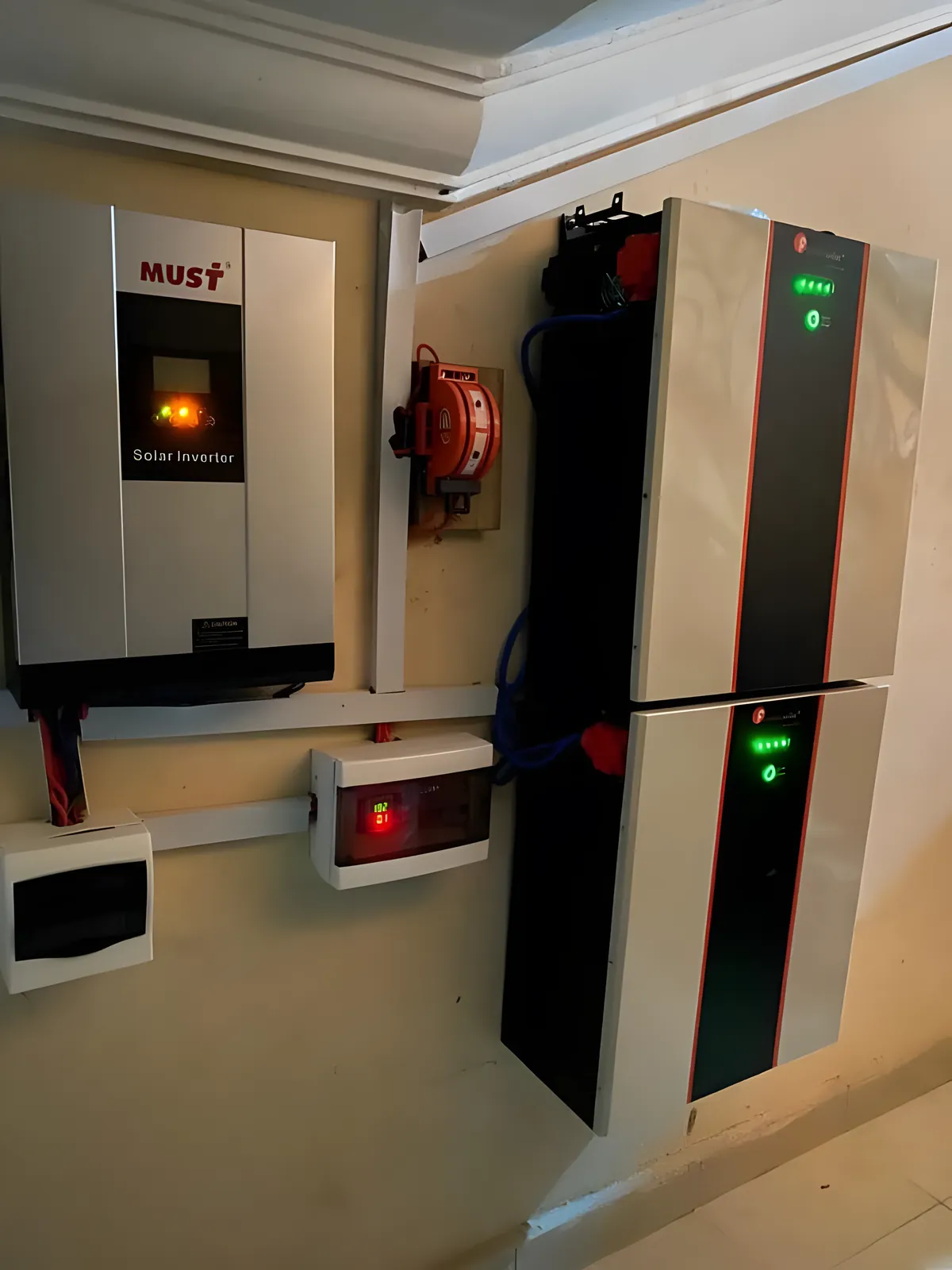 Wall-mounted lithium battery beside an inverter